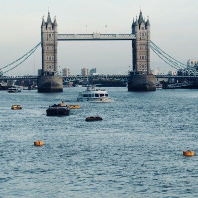 white and black boat on sea near bridge during daytime